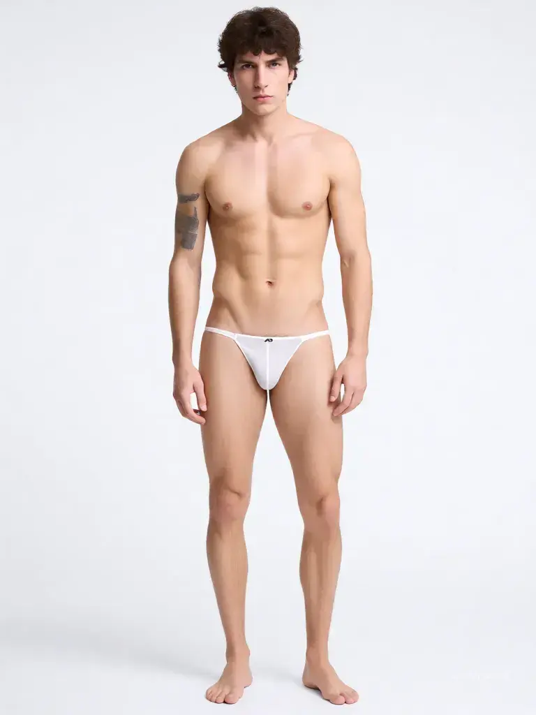 Qwen Intimate output showing a male model wearing the white mesh thong on a studio background