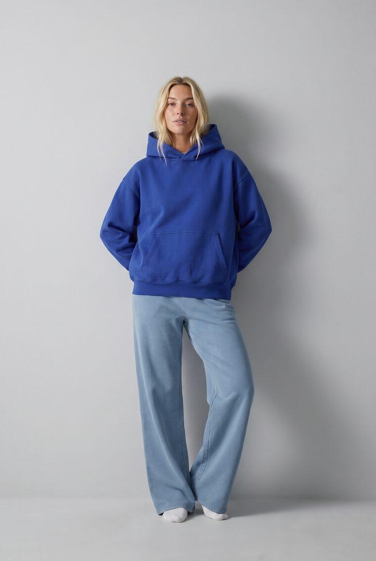 Generated photo of the model wearing the cobalt hoodie with the wide-leg pants