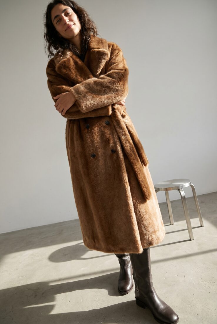 Low-angle flash look on concrete, belted fur coat