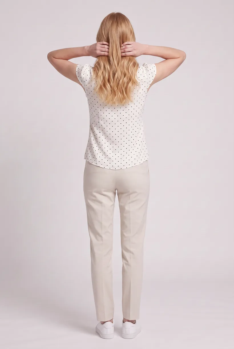 Model wearing the same polka-dot tie-neck blouse, full-body back camera edit on the Pure White studio, generated with nano-banana-pro through the Product page set template