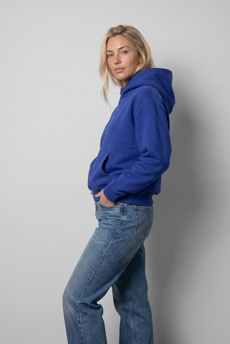 Cobalt hoodie paired with jeans, on model