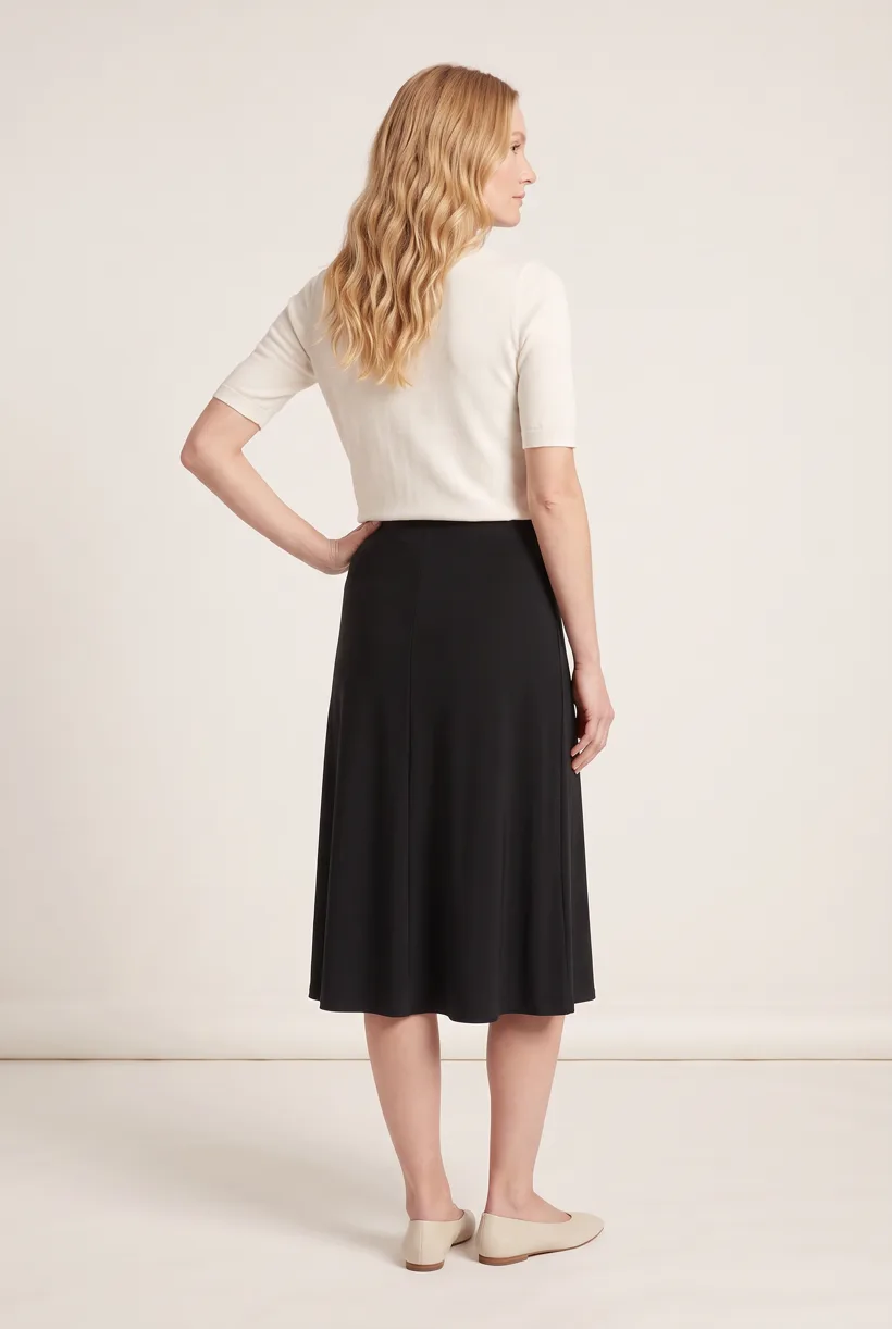 Model wearing the same black fluid midi skirt, full-body back camera edit on the Pure White studio, generated with nano-banana-pro through the Product page set template